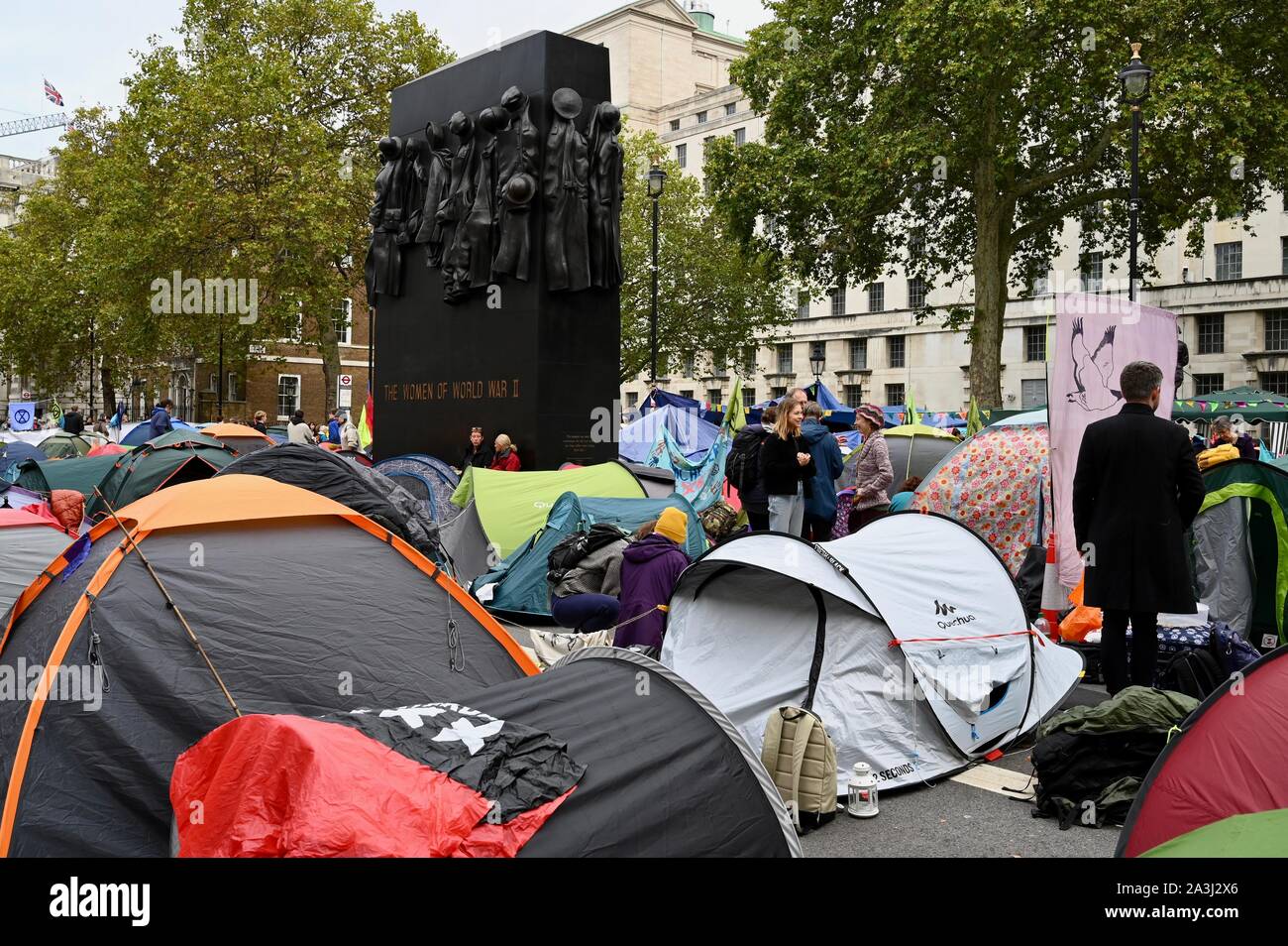 Tents surround the Monument to the Women of `World War II. Extinction Rebellion Protest Day Two, Whitehall, London. UK Stock Photo